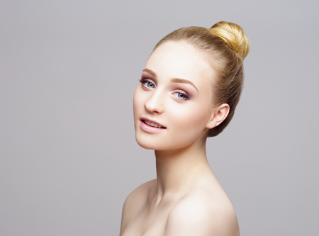 Beauty close-up portrait of beautiful, fresh and healthy girl over grey background.の写真素材