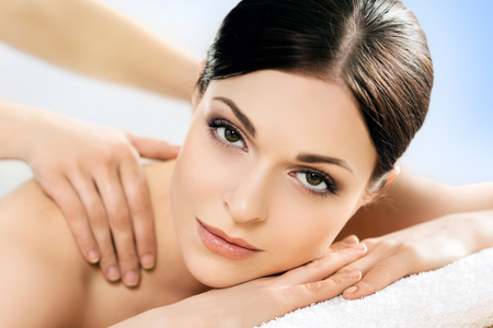 Beautiful, young and healthy woman in spa salon. Massage treatment, traditional medicine and healing concept.の写真素材