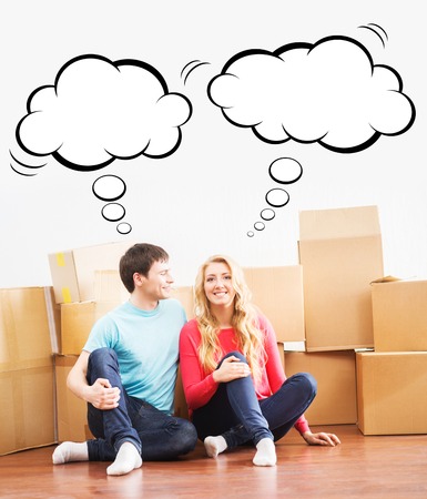 Lovely, young couple with boxes moving in a new home. Comics concept.の写真素材
