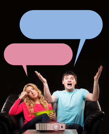 Woman being bored while her husband being emotional about sport game. Comics concept.の写真素材