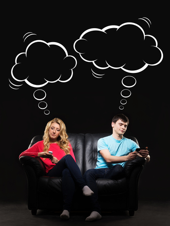 Young couple having disinterest in talking to each other being absorbed by social networks. Comics concept.の写真素材