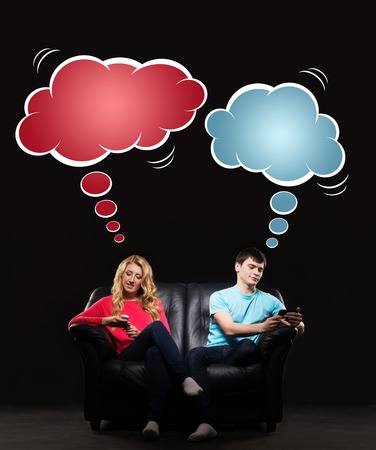 Young man and woman sitting on the sofa absorbed by their gadgets. Comics concept.の写真素材