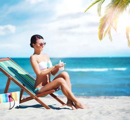 Beautiful, young, attractive girl in bikini taking a rest near the sea. Vacation, resort, holiday concept.の写真素材