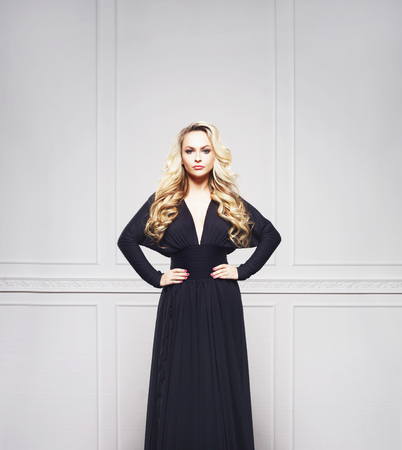 Beautiful, attractive model posing in a black dress. Fashion, beauty, glamour concept.の写真素材