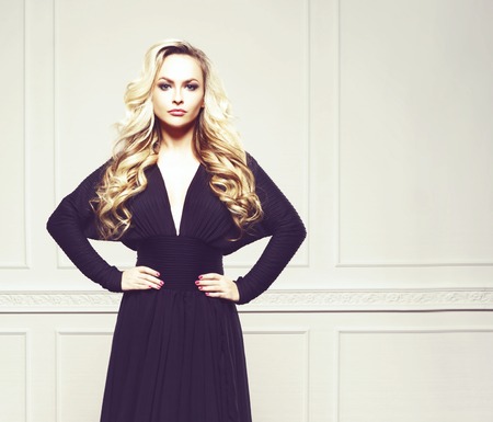 Sexy and attractive young girl posing in a black dress. Beauty, fashion, glamour concept.の写真素材