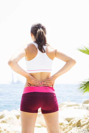 Fit and sporty woman training outside. Girl with a perfect body exercising outdoor.の写真素材