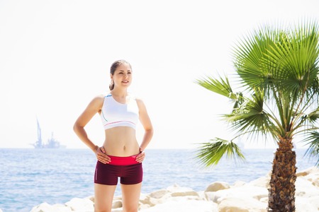 Fit and sporty woman training outside. Girl with a perfect body exercising outdoor.の写真素材
