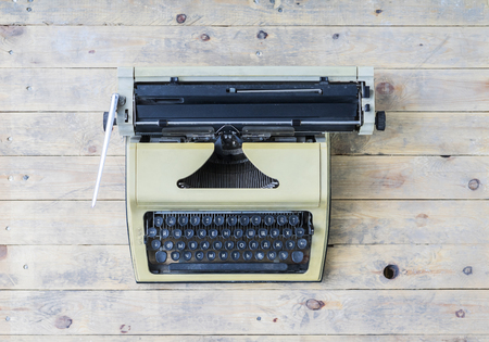 Retro typewriter on a vintage wooden background.の写真素材