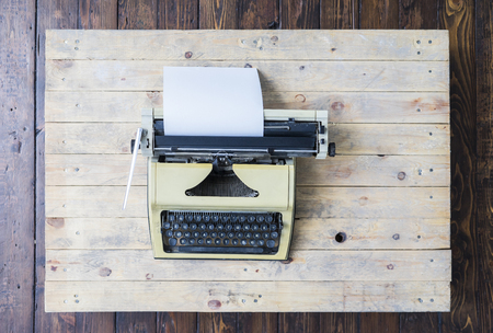 Retro typewriter on a vintage wooden background.の写真素材