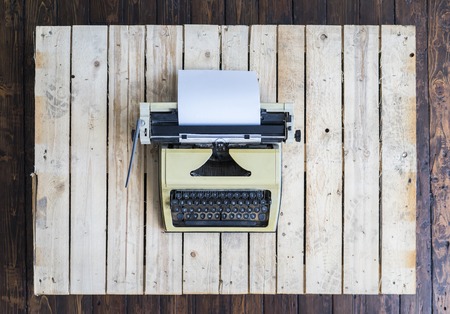 Retro typewriter over vintage wooden background.の写真素材