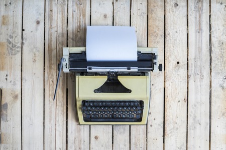 Retro typewriter on a vintage wooden background.の写真素材