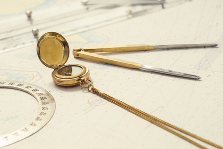 Navigation still-life. Skipper equipment, compass, ruler, protractor and a map. Sailing concept.の写真素材