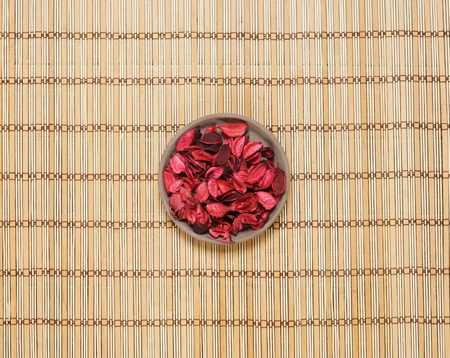 Plate with aroma petals on bamboo mat. Spa, beauty, treatment concept.の写真素材