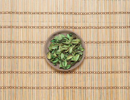 Plate with aroma petals on bamboo mat. Spa, beauty, treatment concept.の写真素材