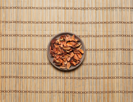 Plate with aroma petals on bamboo mat. Spa, beauty, treatment concept.の写真素材