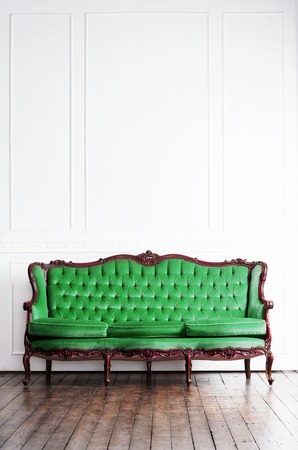 Ancient sofa in a retro interior. Vintage background.の写真素材
