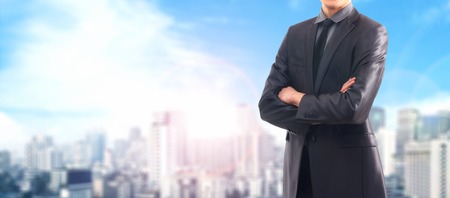 Businessman and a city. Blurry background.の写真素材