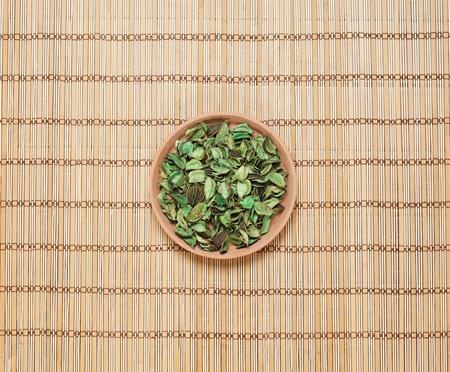 Plate with aroma petals on bamboo mat. Spa, beauty, treatment concept.の写真素材