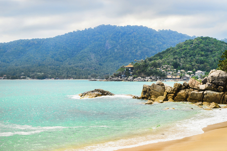 Beautiful bay with crystal clear water. An island with tropical forest on the background.の写真素材