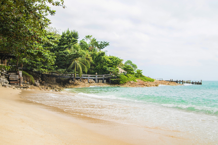 Scene of idyllic beach and forest with an old bridge.の写真素材