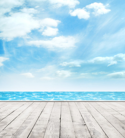 Wooden pier, exotic sea and a blue sky. Beautiful summer background. Vacation and traveling concept.の写真素材