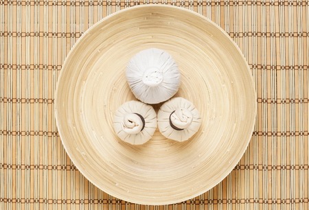 Massage bundles on a plate on bamboo mat. Spa, health, treatment, concept.の写真素材