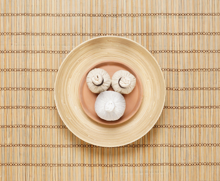 Massage bundles on a plate on bamboo mat. Spa, health, treatment, concept.の写真素材