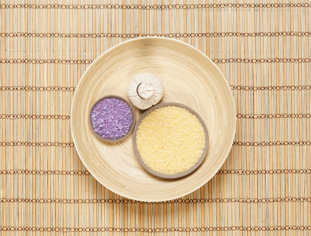 Massage bundle on a plate with bath salt over bamboo mat. Spa, health, treatment concept.の写真素材
