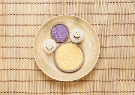 Massage bundle on a plate with bath salt over bamboo mat. Spa, health, treatment concept.の写真素材