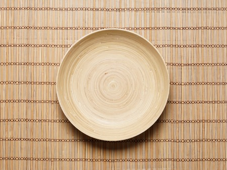 Empty plate on bamboo mat. Health, spa, treatment concept.の写真素材
