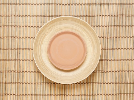 Empty plates on bamboo mat. Health, spa, treatment concept.の写真素材