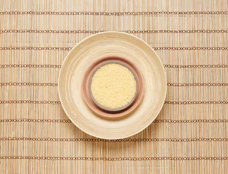 Plate with bath salt on bamboo mat. Health, treatment, spa concept.の写真素材