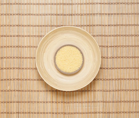 Plate with bath salt on bamboo mat. Health, treatment, spa concept.の写真素材