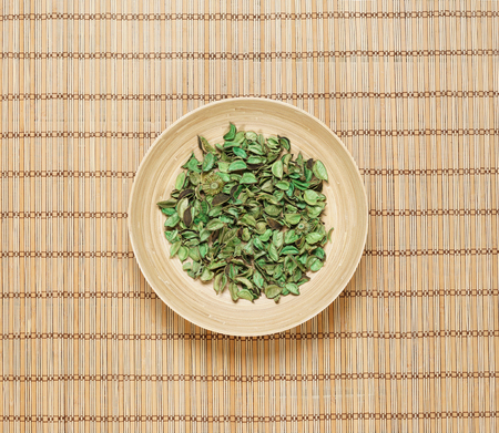 Plate with aroma petals on bamboo mat. Spa, beauty, treatment concept.の写真素材
