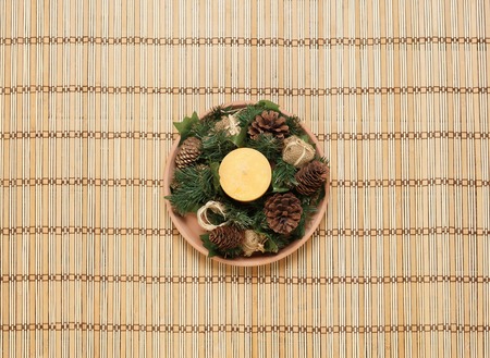 Christmas candle on a plate. Christmas, holiday, spa concept.の写真素材