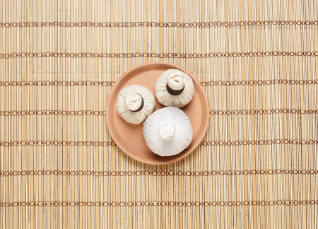 Massage bundles on a plate on bamboo mat. Spa, health, treatment, concept.の写真素材