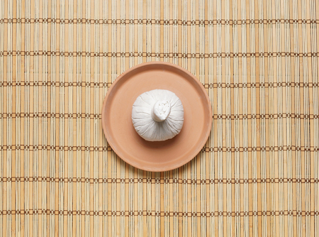 Massage bundle on a plate on bamboo mat. Spa, health, treatment, concept.の写真素材