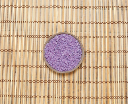 Plate with bath salt on bamboo mat. Health, treatment, spa concept.の写真素材