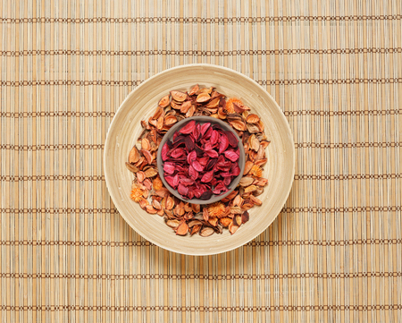 Plate with aroma petals on bamboo mat. Spa, beauty, treatment concept.の写真素材