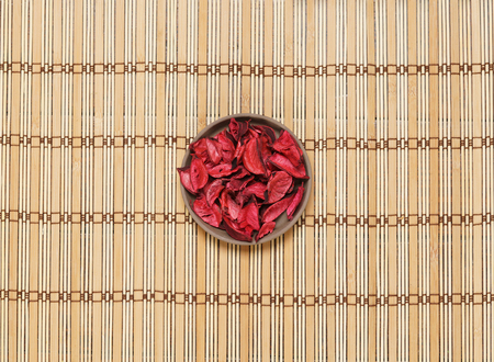 Plate with aroma petals on bamboo mat. Spa, beauty, treatment concept.の写真素材