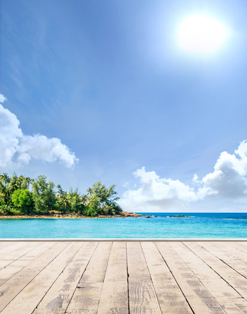 Wooden pier, exotic sea and a blue sky. Beautiful summer background. Vacation and traveling concept.の写真素材