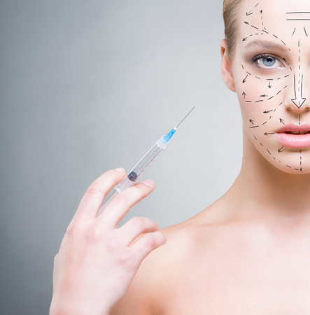 Portrait of healthy, young and beautiful girl ready for injection. Medicine, spa, plastic surgery and skin care concept.の写真素材