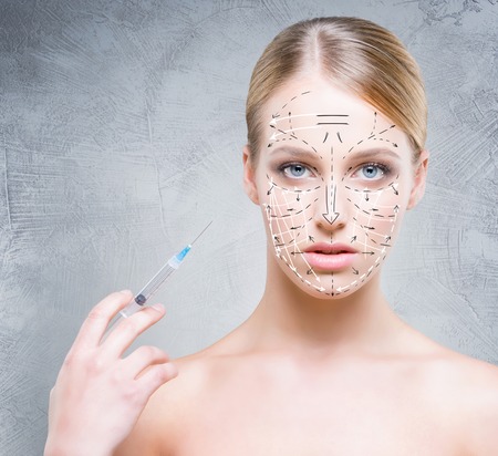 Close-up portrait of young, beautiful and healthy woman ready for a injection. Plastic surgery victim concept.の写真素材