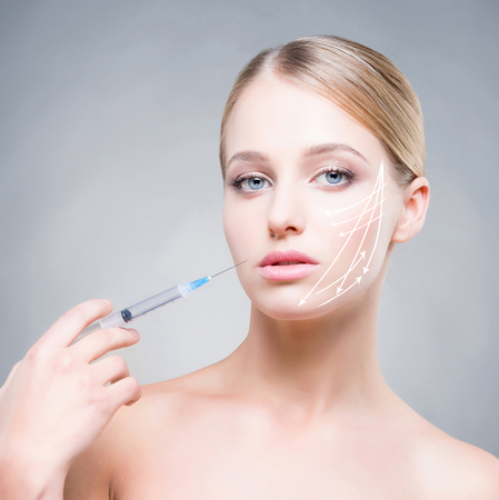 Close-up portrait of young, beautiful and healthy woman ready for a injectionの写真素材