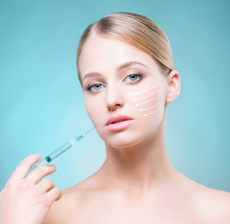 Portrait of healthy, young and beautiful girl ready for injection. Medicine, spa, plastic surgery and skin care concept.の写真素材
