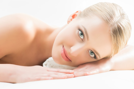 Beautiful woman laying on a mat in beauty salon.の写真素材