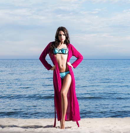 Young, beautiful, sporty and sexy woman posing on the beachの写真素材
