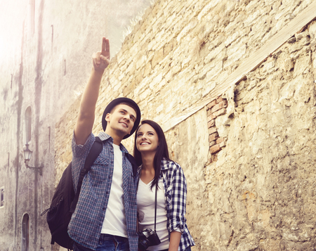 Travelling couple of hipsters: walking around old town. Vacation, summer, holiday, tourism: concept.の写真素材