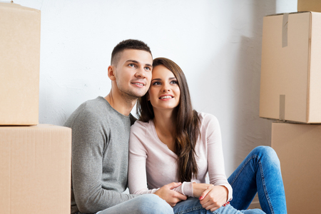Young couple moving in a new home. Man and woman with boxes.の写真素材