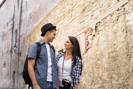 Beautiful, smiling couple having a pleasant walk in old town.の写真素材